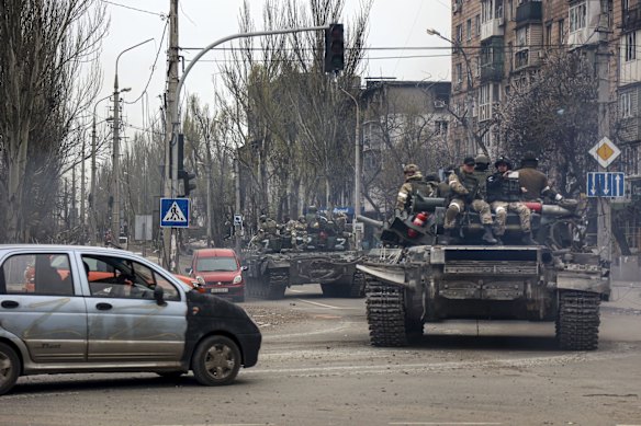 Russian tanks roll along a street in an area controlled by Russian-backed separatist forces in Mariupol.