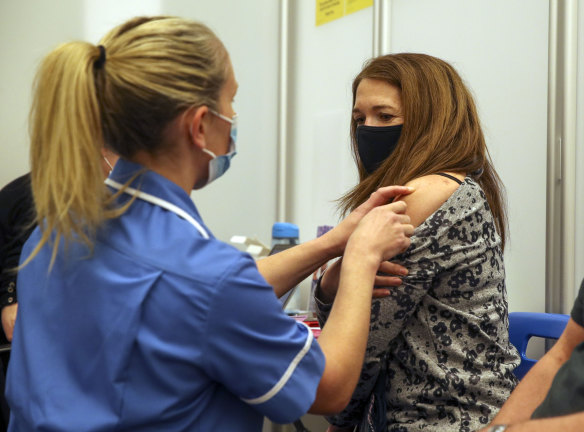 A woman receives the Moderna COVID-19 vaccine in Reading, England.