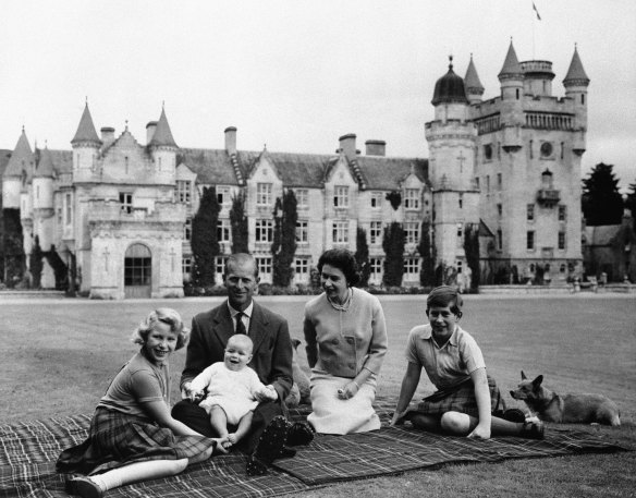 Prince Philip, Queen Elizabeth II, and their children, Prince Charles, right, Princess Anne and Prince Andrew, on the lawn of Balmoral Castle, in Scotland in 1960.