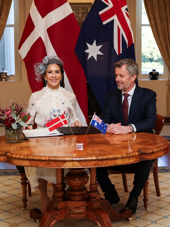 Queen Mary and King Frederik X of Denmark sign the visitors’ book at Government House in Canberra on Sunday.