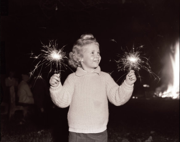 Yvonne Chladell of Bellevue Hill with sparklers on Bonfire night, Waverley, 24 May 1963