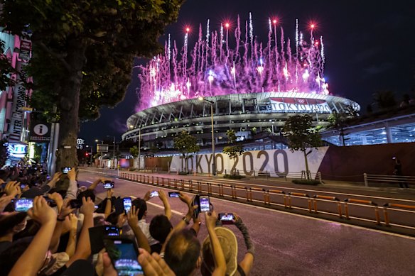 People take photographs of fireworks during the Opening Ceremony of the Tokyo 2020 Olympic Games at Olympic Stadium on July 23, 2021 in Tokyo, Japan.