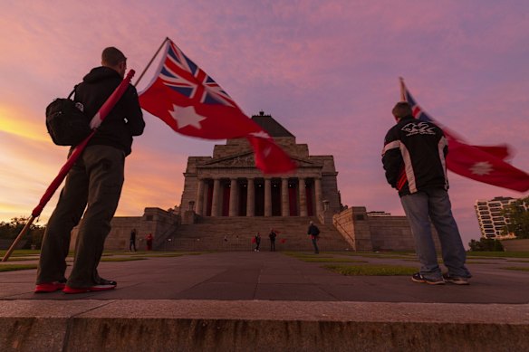 People pay their respects during an Anzac Day service at the Shrine of Remembrance in Melbourne on Saturday.