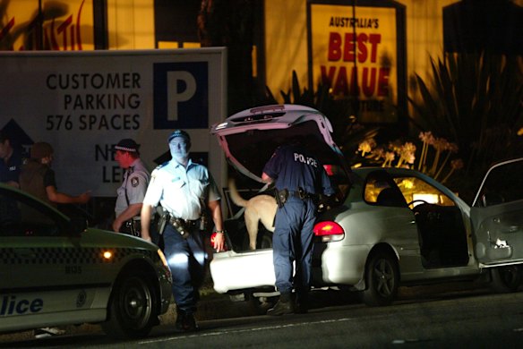 Police search a vehicle with a drug detection dog in the Cronulla area the night after the riots.