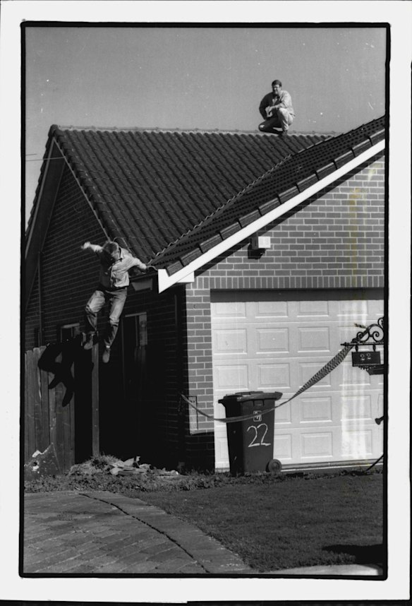 Police continued to search the house of Ivan Milat at 22 Cinnabar Av Eagle Vale, for evidence in connection with the task force air investigation into the backpacker murders.
Const. Steve Blackmore (jumping) and Det. Sen. Const. Andrew Grosse examine the roof. May 25, 1994.