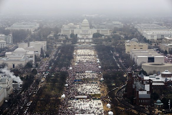 With the U.S. Capitol in the background, a crowd overflows onto the National Mall during the Women's March on Washington during the first full day of Donald Trump's presidency.