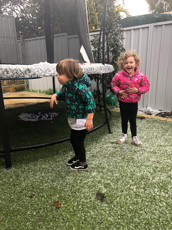 Little Nate and Coco enjoying the 'snow' in their Melville backyard.