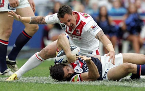 The Dragons Nathan Fein swoops over the Roosters Anthony Minichiello.