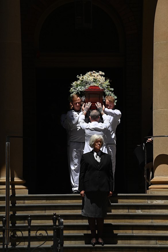 Australian navy personnel carry the coffin out of the church.