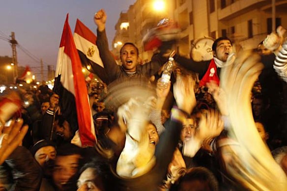 Protesters celebrate outside the presidential palace in Cairo after President Hosni Mubarak stepsd down.