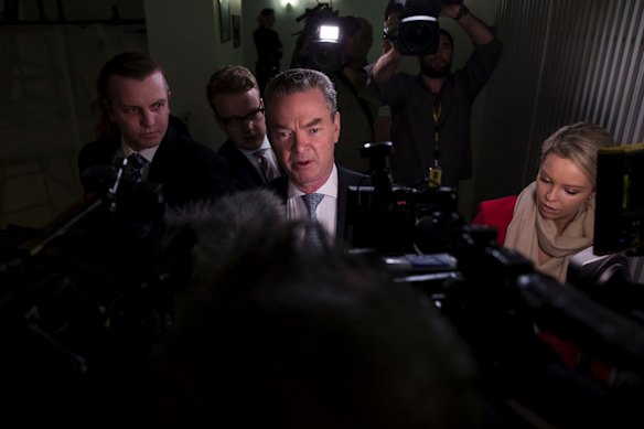 Leader of the House Christopher Pyne is surrounded by the media as he walks between tv interviews in the Press Gallery at Parliament House in Canberra on August 21, 2018.