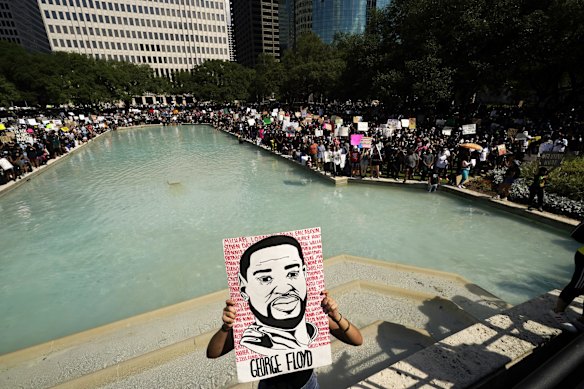 People rally to protest the death of George Floyd in Houston on Tuesday.