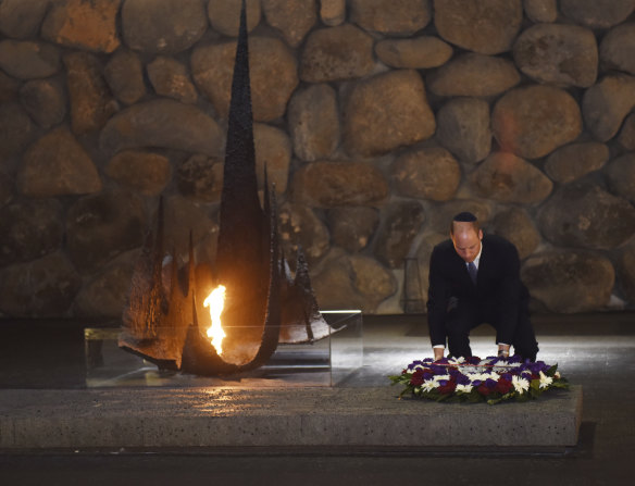 Prince William lays a wreath during a memorial ceremony for Holocaust victims.