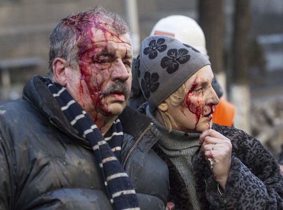 Wounded people are seen after clashes with riot police in central Kiev February 18, 2014. Ukrainian riot police advanced on the heart of 12-week-old protests against President Viktor Yanukovich on Tuesday and security forces set a deadline to end disturbances after at least five protesters were reported killed in a day of clashes.