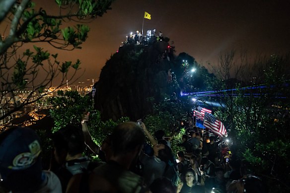 Pro-democracy supporters wave laser pointers, cellphone and lanterns as they gather on Lion Rock on mid-autumn festival, on September 13, 2019 in Hong Kong, China. 