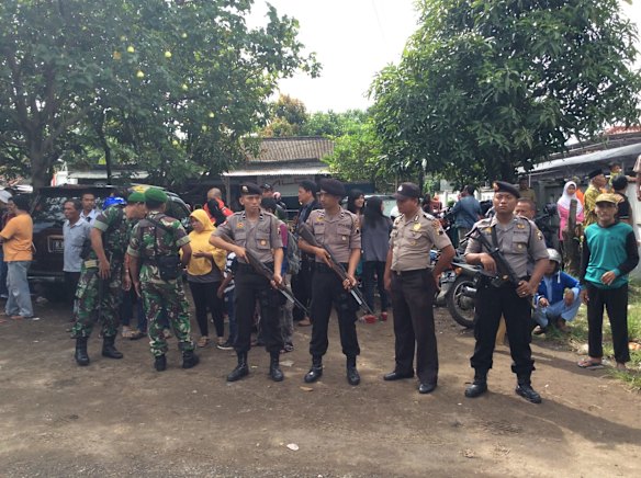 Armed police outside the harbour in Cilacap where Andrew Chan and Myuran Sukumaran were ferried to Nusakambangan island.