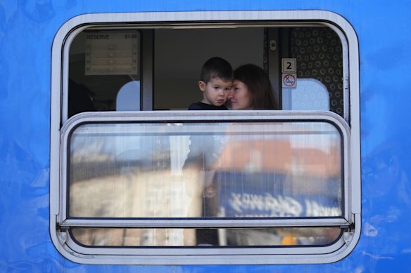 Refugees fleeing the conflict from neighboring Ukraine wait for their departure to Prague at the Przemysl train station in Przemysl, Poland, Saturday, Feb. 26, 2022. (AP Photo/Petr David Josek)