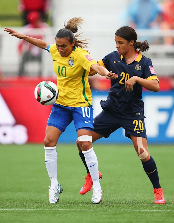 Marta of Brazil holds off Samantha Kerr of Australia.