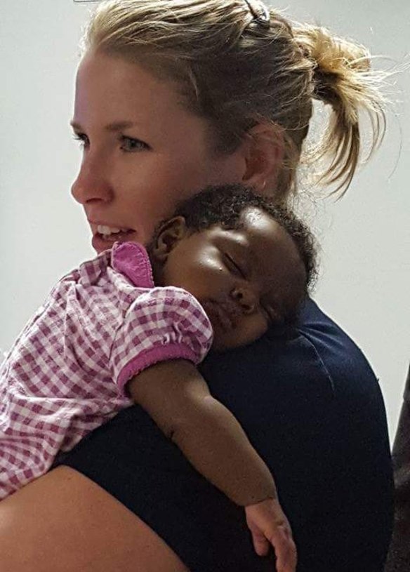 Michelle Burton comforts a baby after responding to a call in Alabama. 