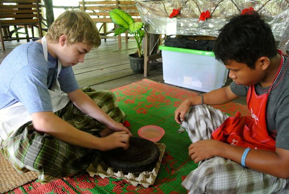 Locals give a class in Karonese cooking to tourists at the riverside cafe in Tangkahan, North Sumatra.