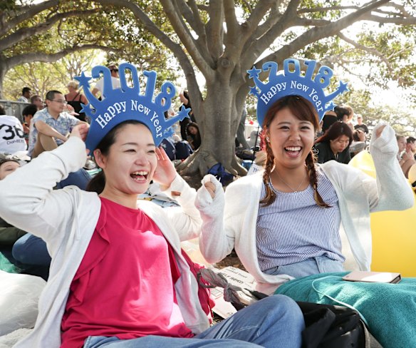 Yuka Aoyama and Aguri Hara wait for the New Year's Eve fireworks at Mrs Macquaries Chair.