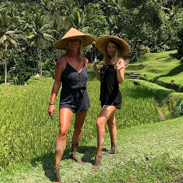 The author (right) with a friend, learning to plant rice in Bali.