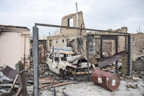 A destroyed car amid the ruins of a building in Bucha.