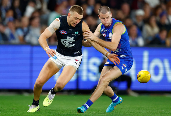 Bulls at a gate: Patrick Cripps and Bailey Scott battle for possession on Friday evening.