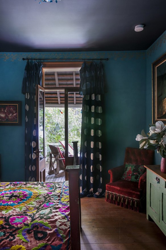 Curtains in Sally Campbell silk flank the high french doors leading to the verandah. The Victorian red velvet chair is from The Country Trader.