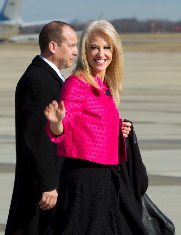 Counselor to President Kellyanne Conway waves to the media before President Donald Trump's arrival at Andrews Air Force One.
