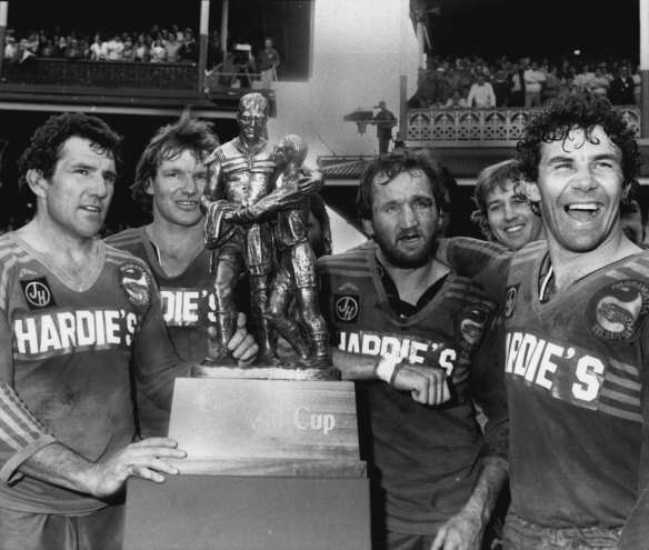Mick Cronin, Peter Wynn, Ray Price, and captain Steven Edge pose with the Winfield Cup after the 1982 premiership grand final against Manly-Warringah. This was the first appearance of the classic trophy designed by Alan Ingham, and depicting Norm Provan and Arthur Summons.