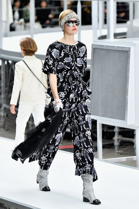A model walks the runway during the Chanel show. It was all about metallics, space prints and oversize embellishments. 