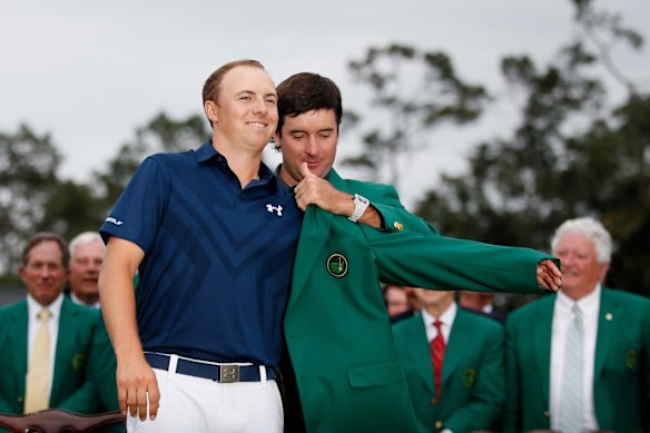 Bubba Watson presents Jordan Spieth of the United States with the green jacket.
