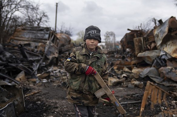 Yehor, 7, stands holding a wooden toy rifle next to destroyed Russian military vehicles near Chernihiv. Witnesses said multiple explosions believed to be caused by missiles struck the western Ukrainian city of Lviv early Monday as the country was bracing for an all-out Russian assault in the east.