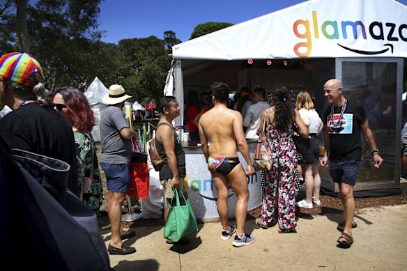 A colourful crowd enjoy the festivities and entertainment at the Gay & Lesbian Mardi Gras Fair Day at Victoria Park, Sydney.