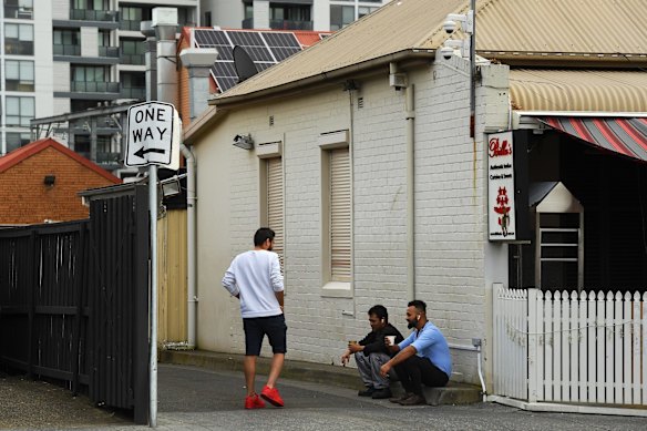 Friends meet for a coffee in a laneway in Harris Park.