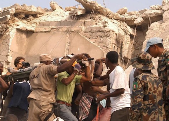 People carry an injured person  in Port-au-Prince.