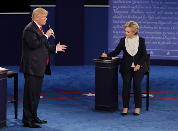 Republican presidential nominee Donald Trump speaks while Democratic presidential nominee Hillary Clinton takes notes during the second presidential debate at Washington University in St. Louis, Sunday, Oct. 9, 2016. (AP Photo/John Locher)