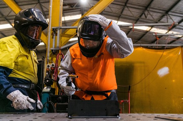  Try anthing: Morrison dons his gloves and hard hat to weld at Opie Manufacturing.