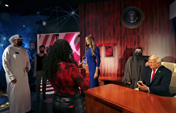 Visitors view the wax versions of Donald Trump and his wife Melania at the opening of the Madame Tussauds museum, in Dubai.