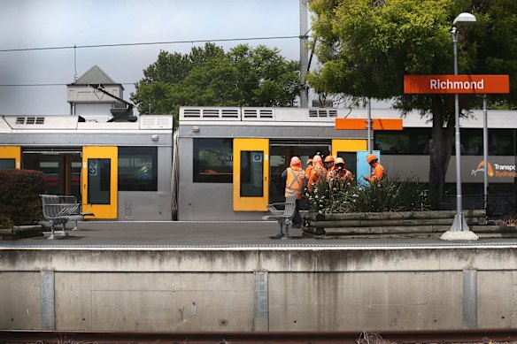 Workers inspect scene of train accident at Richmond railway station.