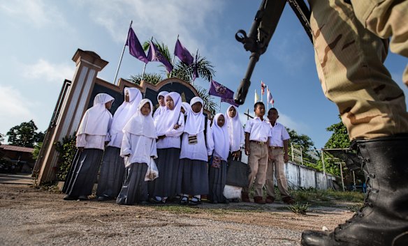 Each morning and night soldiers, police and militia across the four strife-torn provinces guard students as they make their way to Thai government schools like this one in Laewaeh village in the district of Thung Yang Daeng.
