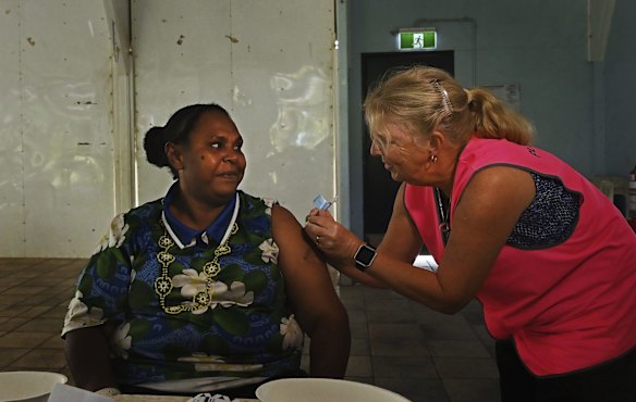 Norah Tabuai, 37, receives her second AstraZeneca COVID-19 vaccination on Saibai Island from a Queensland Health nurse. The vaccine rollout resumed in the Torres Strait islands after it was paused when the federal government on April 8 advised people under 50 years old should not have AstraZeneca due to blot clotting. More than 80 per cent of the Torres Strait population is under the age of 50, according to the 2016 census.