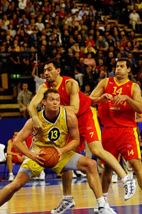 Australia's Luc Longely battles against Spain's Jorge Garbajosa in the men's basketball.