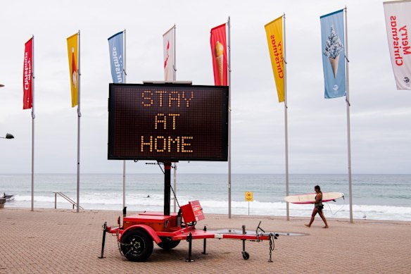 Public warning sign at Manly Beach. After the COVID-19 outbreak in Avalon, the Northern Beaches have been placed back into lockdown.