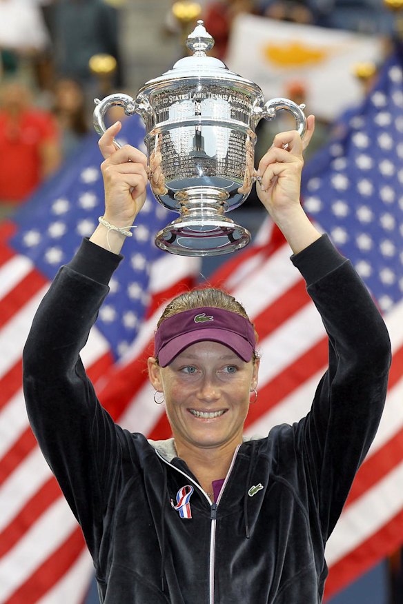 Samantha Stosur of Australia celebrates with the championship trophy after defeating Serena Williams to win the US Open women's singles title.