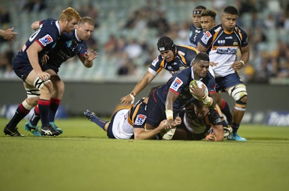 The Rebels' Isi Naisarani barrels into his former Brumbies teammates. 