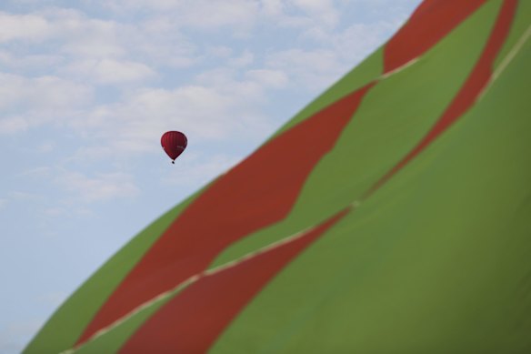 Hot air balloons inflating on the lawns in front of Old Parliament House for the Canberra Balloon Spectacular festival.