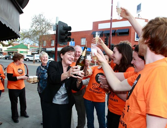 Cathy celebrates with champagne.
