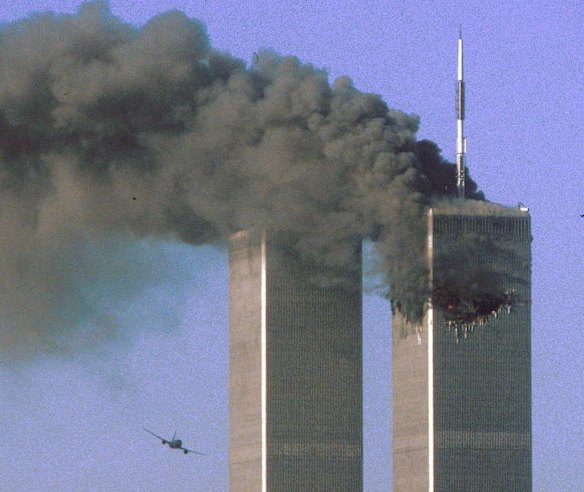Hijacked United Airlines Flight 175 flies toward the World Trade Center twin towers shortly before slamming into the south tower (L) as the north tower burns following an earlier attack by a hijacked airliner in New York City in this photo taken on September 11, 2001.